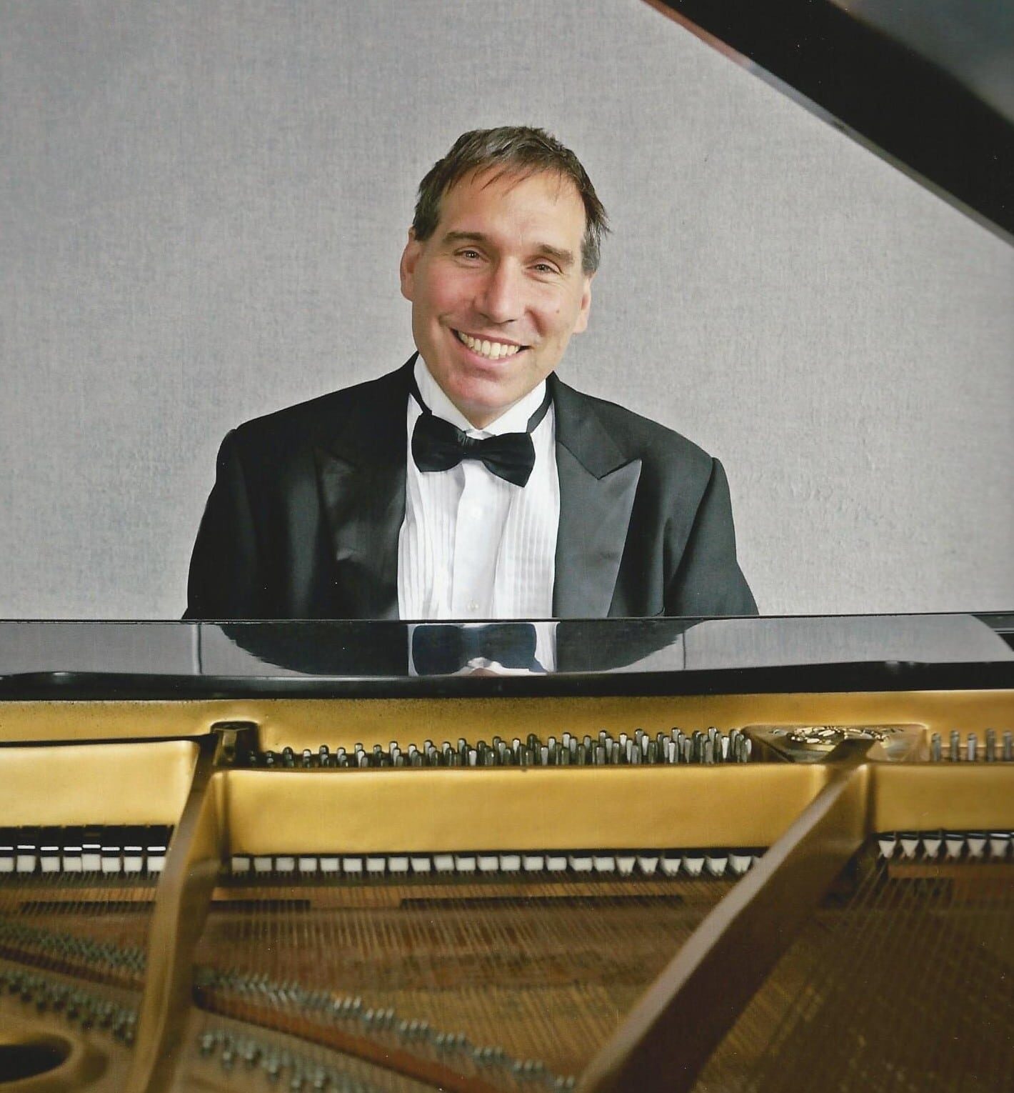 Pianist Frédéric Lacroix smiling at the piano